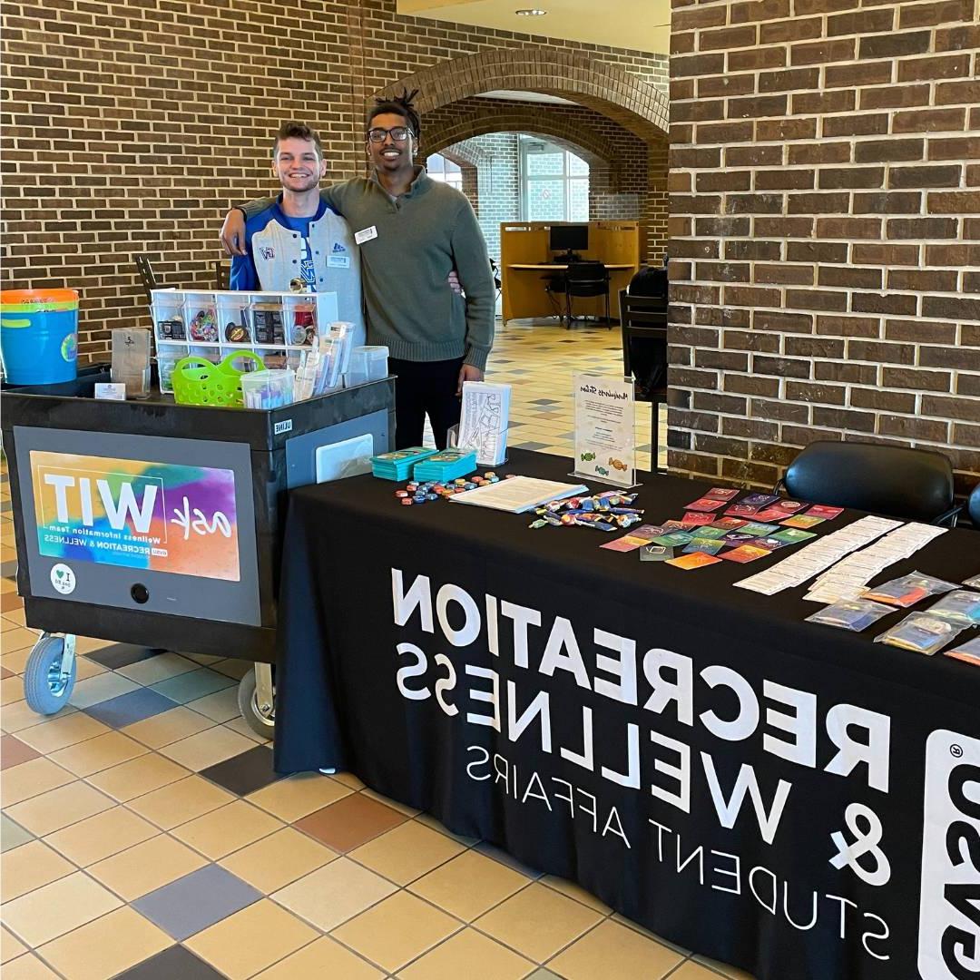 Two WIT peer educators tabling at Kirkhof posing for the picture